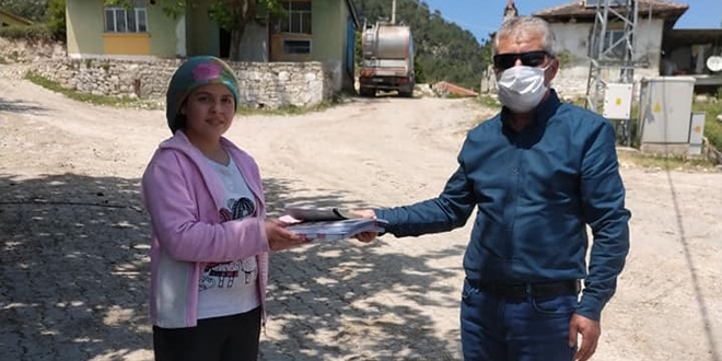 Müdür ve öğretmenler, öğrencilerine evlerinde kitap dağıttı