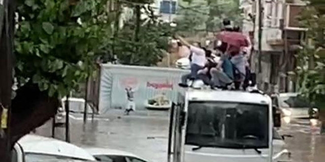Esenyurt'ta göle dönen yolda minibüs üstünde mahsur kaldılar