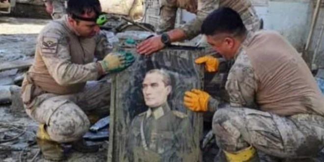Askerler, selde buldukları Atatürk fotoğrafını elleriyle yıkadı