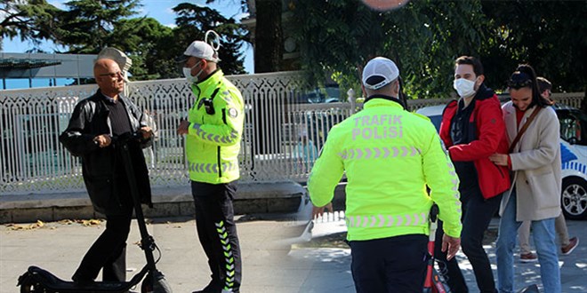 Kaldırımdan giden, yük taşıyan scooter kullanıcılarına ceza