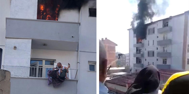 Yangında balkondan atlayan kadını komşusu tuttu